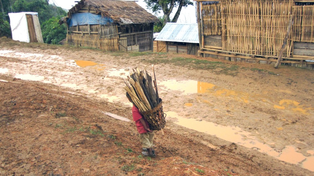 A young child is seen carrying a basket load of firewood, commonly used as a daily fuel by many, in a village in Zunheboto District. Women and children face the biggest brunt of “unfreedom” in the lack of any coherent form of development in Nagaland State.
